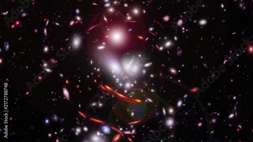 Distant galaxies and clusters of stars glowing in the dark deep space background with gravitational lensing.