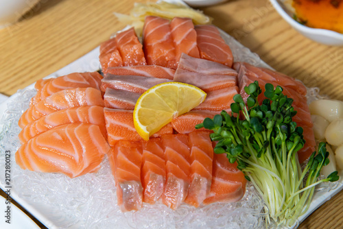 Konstfotografi Angled View of Fresh Salmon Sashimi Platter with Radish Sprouts and Lemon