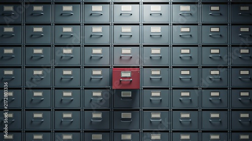 Organized storage drawers with one highlighted red compartment
