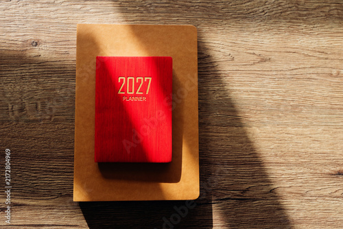 Red 2027 planner notebook on wooden background