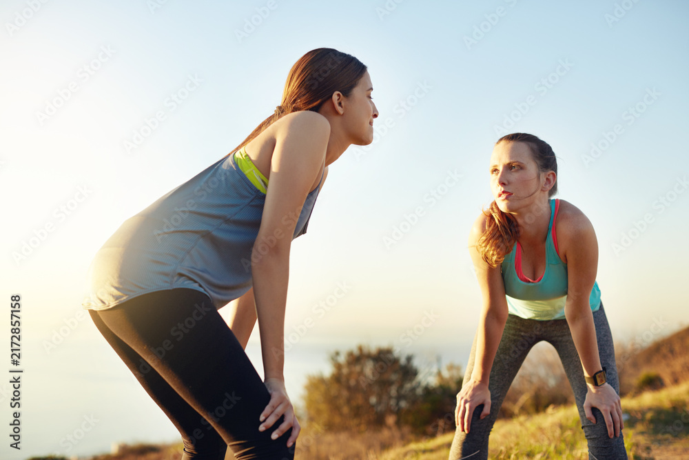 Naklejka premium Outdoor, fitness and girl friends on break for exercise, active or wellness on weekend morning. Challenge, athletes and people with relax in nature for sports cardio, workout or health at trail.