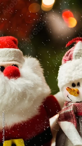 Animation of christmas santa claus and snowman with snow falling