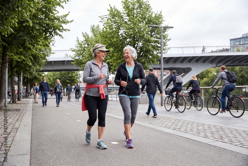 Fototapeta premium Senior women walking together outdoors in city park active lifestyle