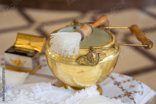 Fotografía Golden baptismal bowl with an angel ornament and aspergillum