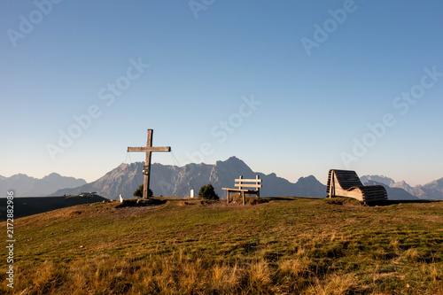 Majestic alpine mountain peaks illuminated by warm golden sunrise light, creating a breathtaking summer landscape in the Austrian Alps, perfect for travel, tourism and premium nature imagery.