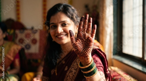 Woman showing intricate henna mehndi design on hand
