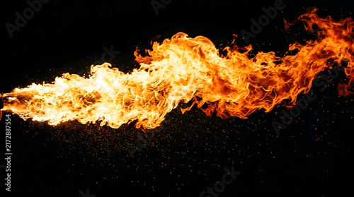 Powerful stream of fiery flames bursting horizontally isolated on black background