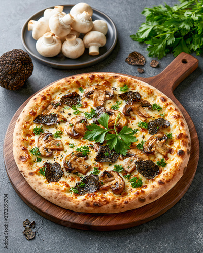 Gourmet Mushroom Truffle Pizza A delectable truffle mushroom pizza is artfully presented on a wooden board, accompanied by fresh mushrooms and a hint of parsley.