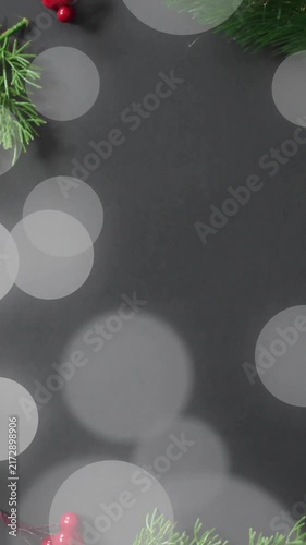 Christmas wreath with red berries and green pine branches over bokeh lights animation