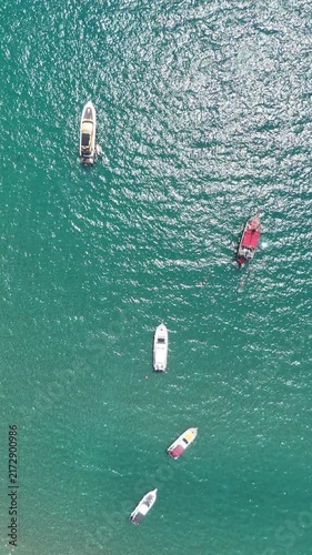 Aerial view of turquoise colored sea with boats and yachts	