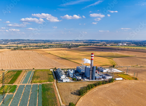 Принти на полотні Factory located in a rural area with fields and blue sky in the background