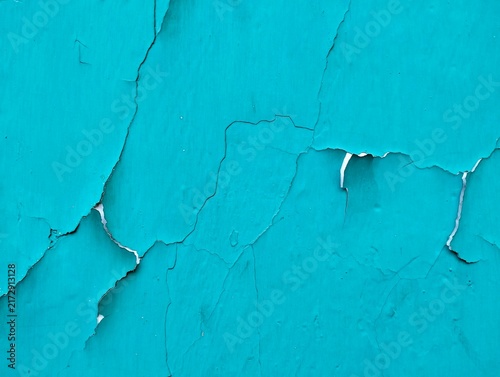 Abstract blue weathered background, cracked teal paint texture on concrete surface