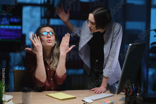 Obraz na płótnie Frustrated businesswomen react during tense office discussion