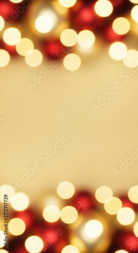 Festive Christmas Bokeh Lights and Red Ornaments on a Golden Background.