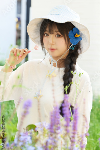 Fotografie Outdoor portrait of a beautiful Chinese girl holding a lollipop.