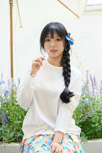 Fotografía Outdoor portrait of a beautiful Chinese girl holding a lollipop.