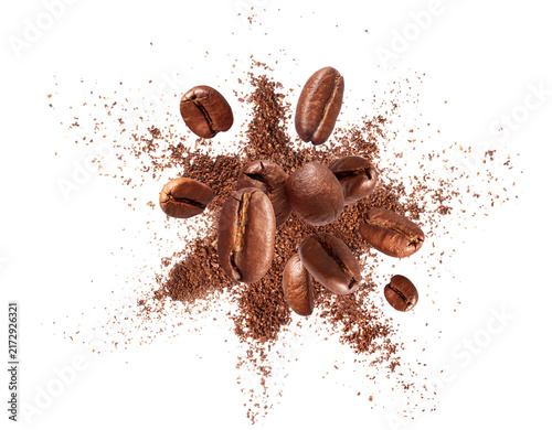Flying roasted coffee beans with explosion of coffee powder isolated on a transparent background