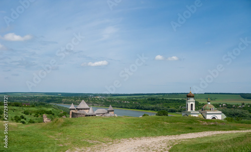 Historic view of Khotyn, Ukraine with a castle and river under a blue sky