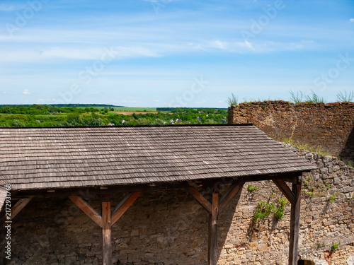 View from the top of Khotyn Fortress shows green fields and blue skies in Khotyn, Ukraine during daytime