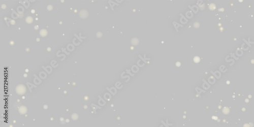 Small golden particles scatter gently across a deep black background. The soft round shapes vary in size and radiate subtle light. This image is ideal for elegant backgrounds and festive.