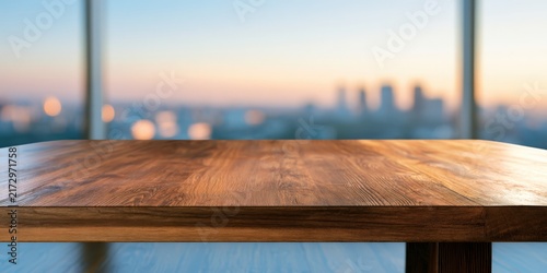 Warm wood table faces city skyline at sunrise