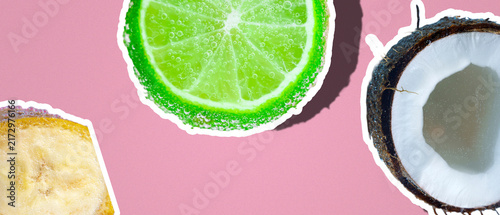 Fresh fruit stickers with lime, coconut, and banana on pink background