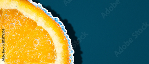 Orange slice with water bubbles sticker on blue background