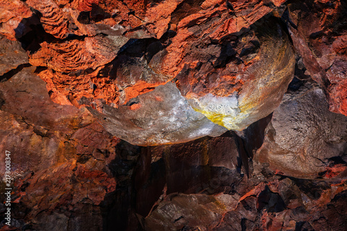 Картината върху платно A broad rounded mass of red lava dominates the cave floor inside Raufarholshellir, Iceland