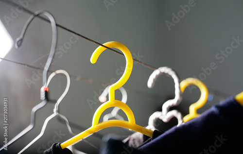 dirty hanger is hanging on the wire clothesline.