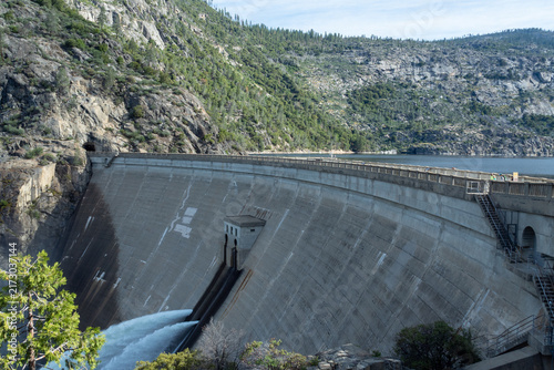 Bild auf Leinwand Concrete arch dam with water release into a valley surrounded by pine forests and granite cliffs, scenic engineering and nature contrast, Hetch Hetchy, Yosemite National Park, California, USA