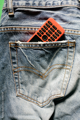 close up of dumb phone in the back pocket denim pant