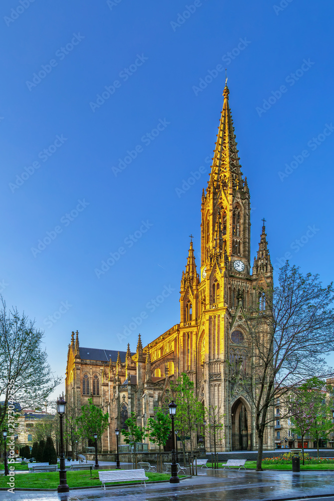Naklejka premium Cathedral of the Good Shepherd in San Sebastian, Spain. Three quarter exterior view. Sunny daylight, blue sky. Neo Gothic