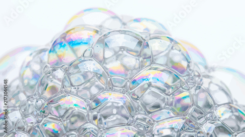 Macro shot of dense iridescent soap bubbles and suds on white background