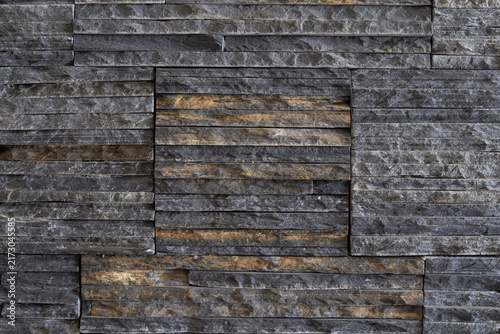 Textured decorative stone cladding made of narrow stacked pieces for modern wall finishing and interior design