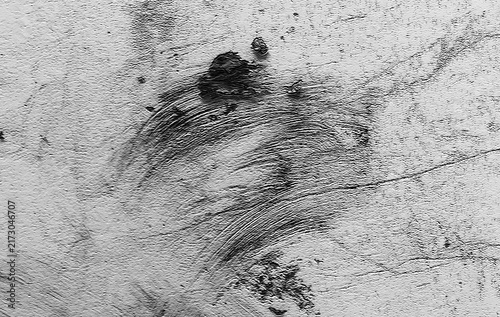 Monochrome abstract grunge texture featuring rough concrete plaster, weathered surface details, and expressive brush stroke marks. Ideal for backgrounds, and modern graphic design projects.  