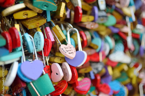 Quadro su tela Multicolored locks on bridges and fences are locks of love, a worldwide romant