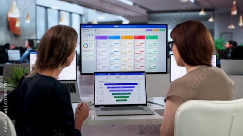 Sales Manager And Assistant Analyze Client Data Using CRM