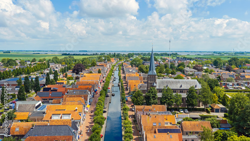 Obraz na plátně Aerial view of a historic canal village with church and traditional boats in Eur
