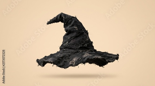 A textured black witch hat isolated on a plain beige background for halloween holiday season design projects