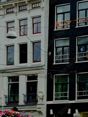 Fotografie Black brick facade of a traditional Dutch building with windows