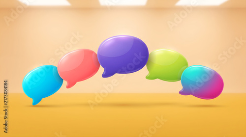 Five glossy colorful three dimensional speech bubbles arranged in a gentle arch across a minimalist studio background creating a vibrant concept for digital social communication