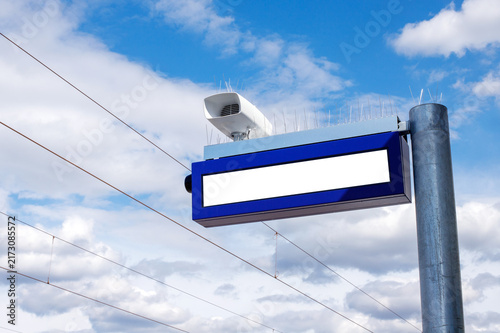 Blank Screen Display and Loudspeaker at Railway Station with Blue Sky