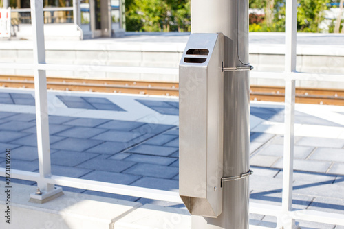 Stainless Steel Outdoor Ashtray Mounted on Pole at Railway Station
