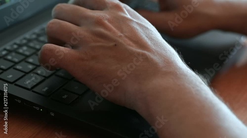 Hand typing  on computer keyboard. Hand typing on computer keyboard pressing on return or enter keypad. Hacker coding or person working. Clicking and writing fast. Close up. 