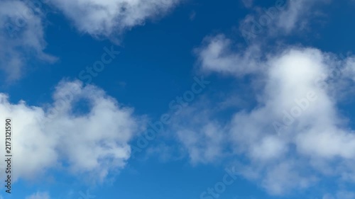 Bright Blue Sky with Soft White Clouds and Natural Daylight
