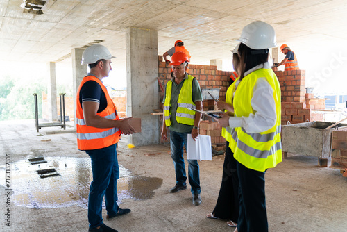 Workers and managers evaluate quality of building materials. Inspectors take into account characteristics of brick to form verification report