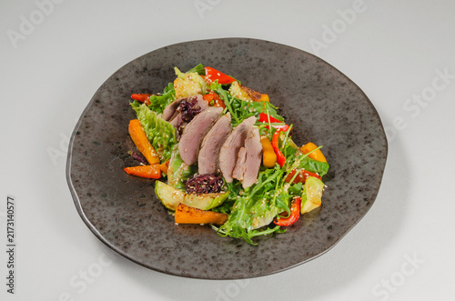 Quadro su tela Warm Duck Breast Salad with Roasted Vegetables Isolated on White Background