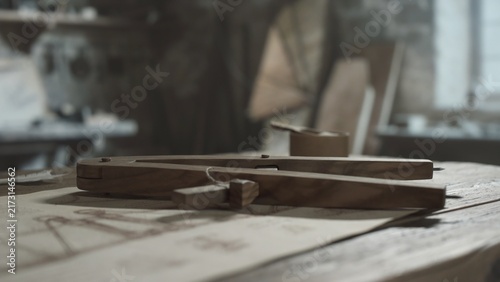 Quadro su tela Medieval wooden proportional compass on a technical sketch sheet on a table insi