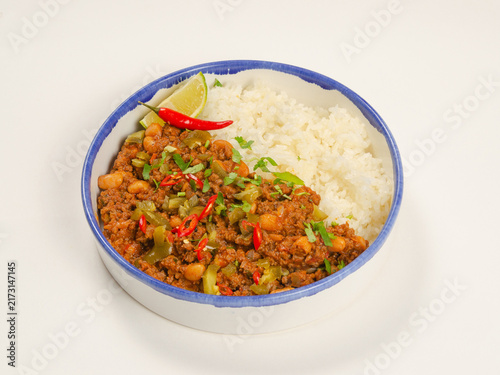 Chili Con Carne with Ground Beef, Beans, Vegetables and Rice in Ceramic Bowl