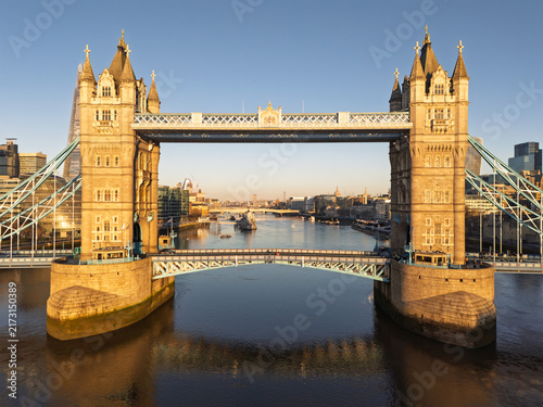 Cuadro en lienzo Aerial view of London's iconic Tower Bridge spanning the River Thames at sunrise, with The Shard and city skyline in the background